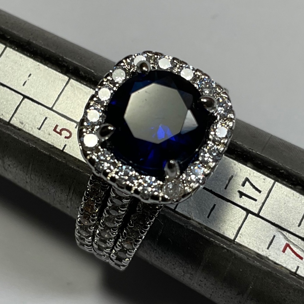 Sterling Silver Ring with a blue stone surrounded by smaller clear stones Size 6